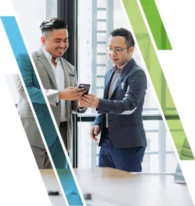 Two men in business attire looking at a smartphone in an office with window background and diagonal graphic overlays.